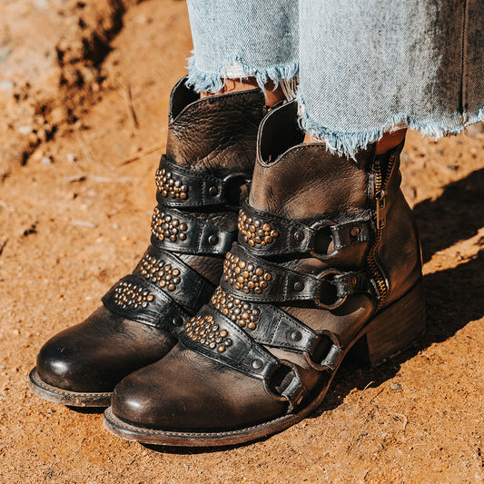 FREEBIRD women's Grady black distressed leather bootie with an inside working zipper, low bock heel and abstract shaft belt detailing