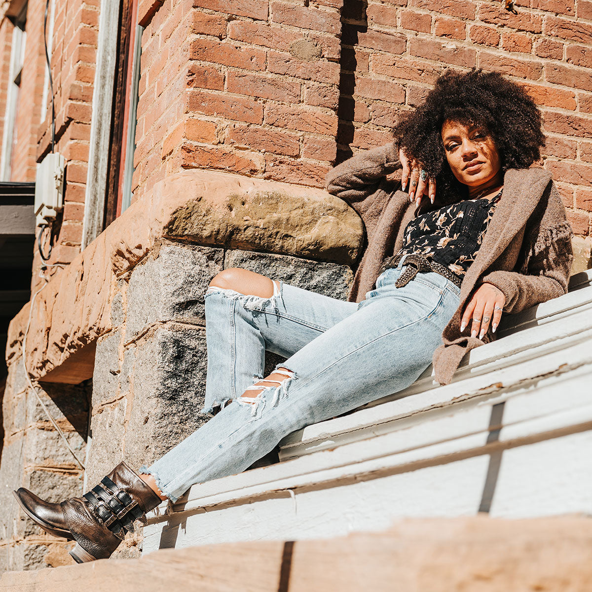 FREEBIRD women's Matteo black distressed leather bootie with a leather shaft overlay, adjustable shaft belts and snip toe construction lifestyle