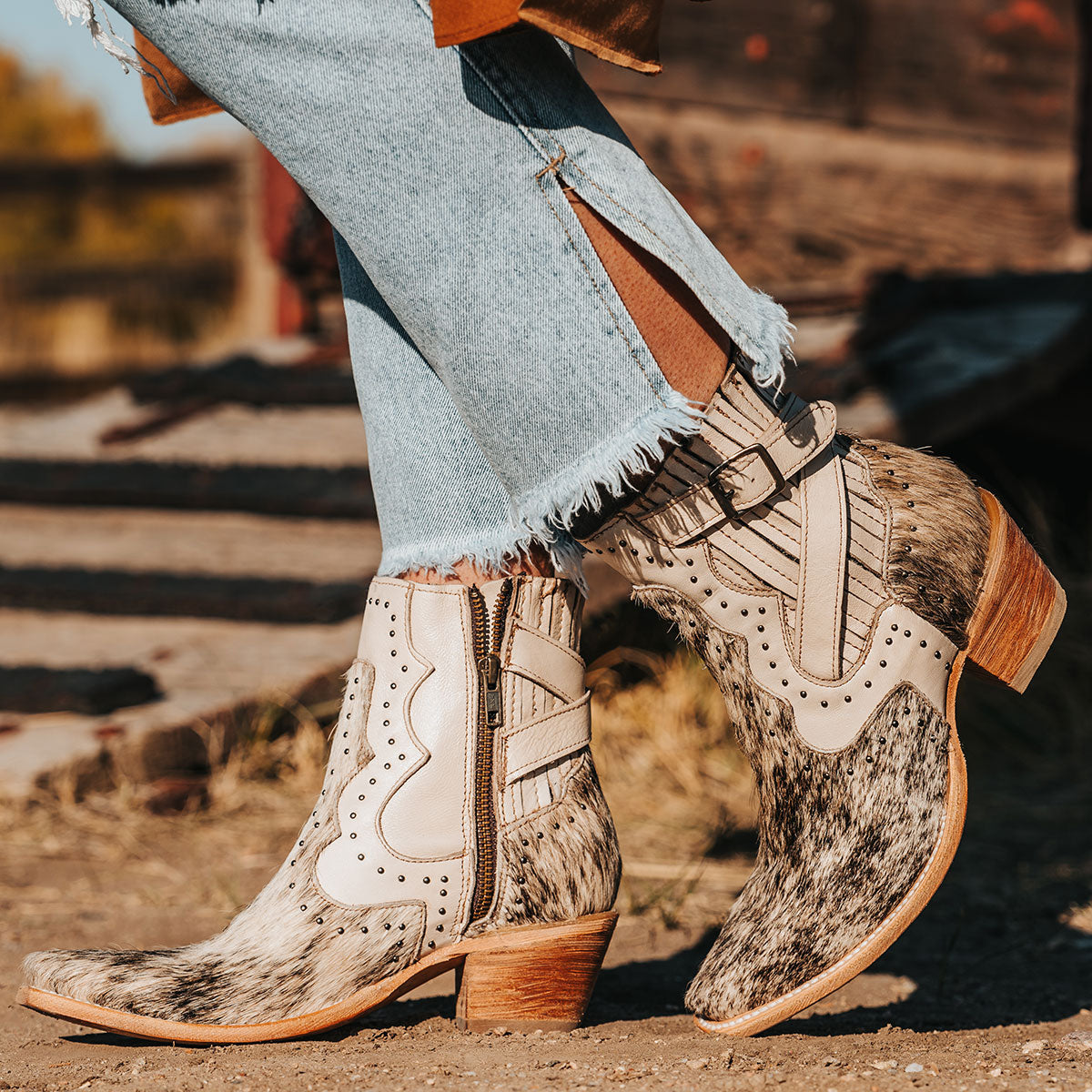 FREEBIRD women's Morgan beige pony multi leather ankle bootie with silver stud embellishments, gore detailing, and buckle straps 