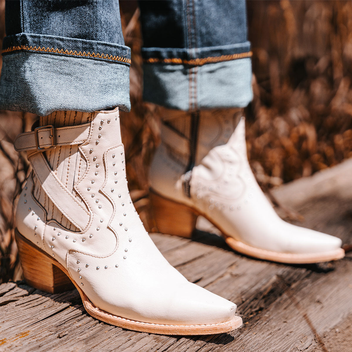 FREEBIRD women's Morgan beige leather ankle bootie with silver stud embellishments, gore detailing, and buckle straps