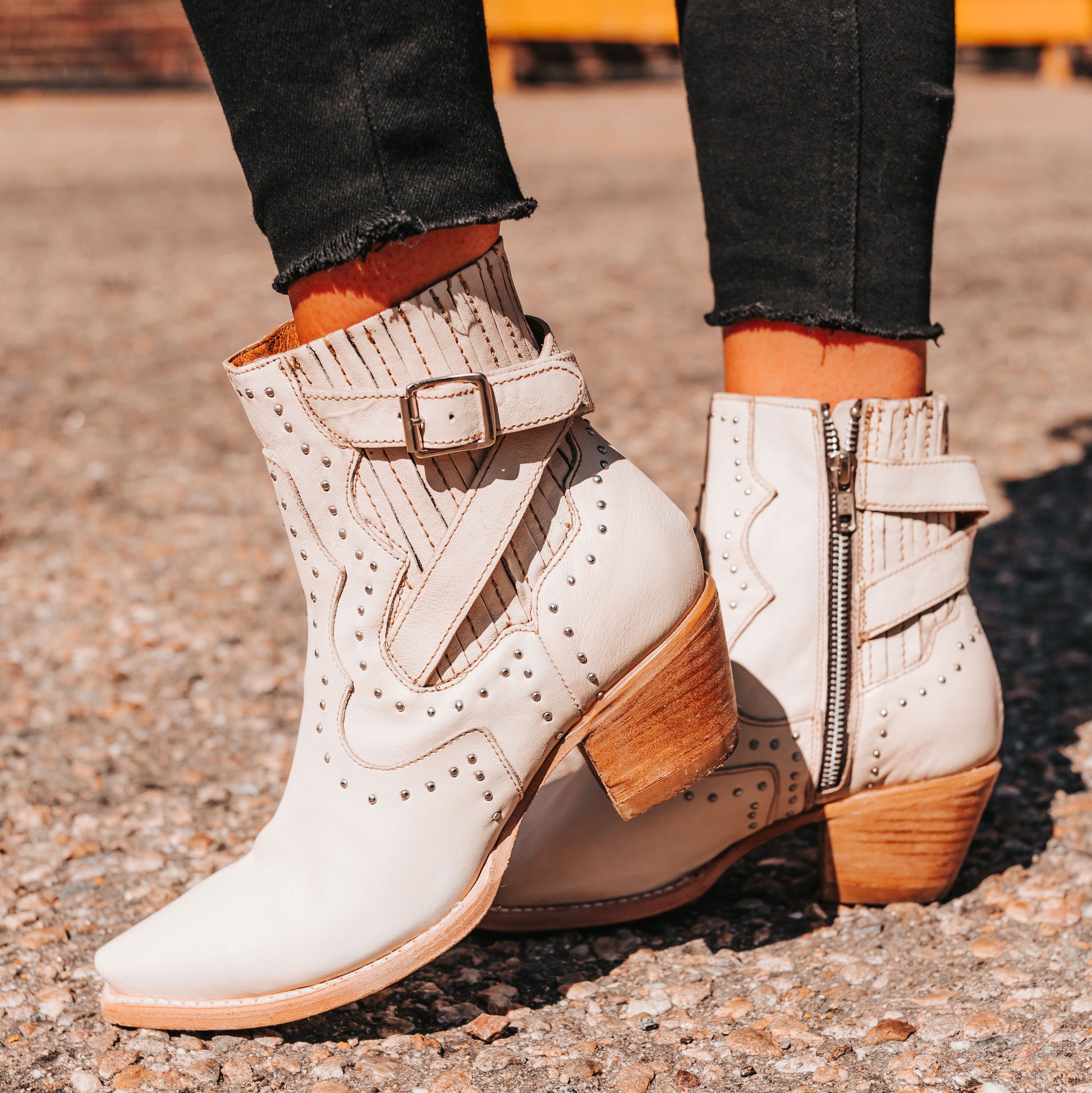 FREEBIRD women's Morgan beige leather ankle bootie with silver stud embellishments, gore detailing, and buckle straps