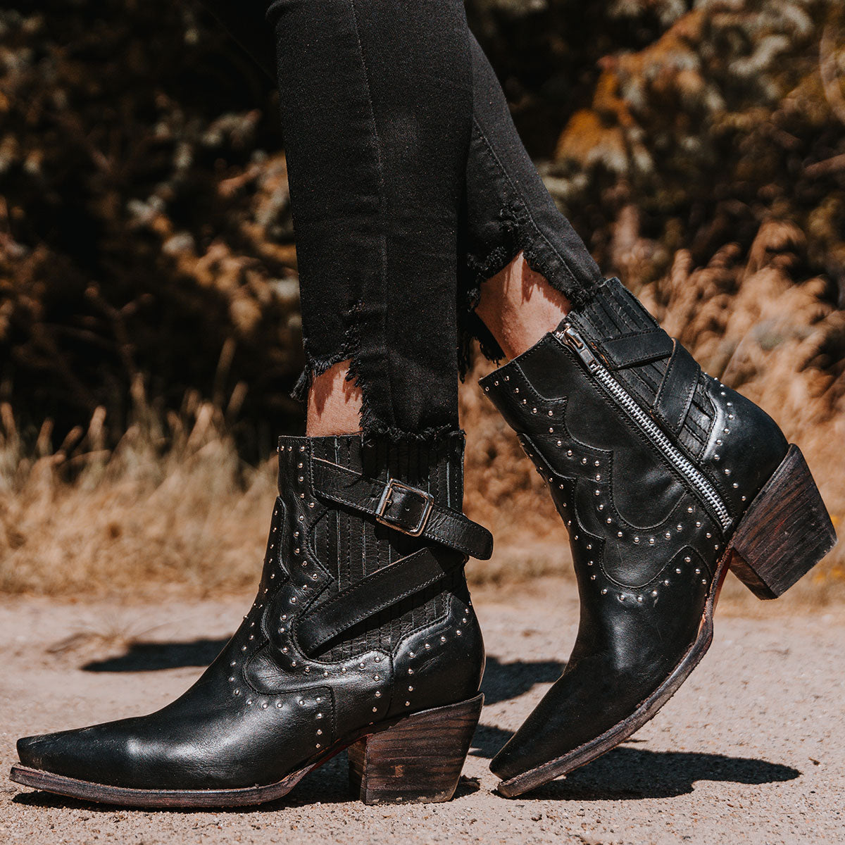 FREEBIRD women's Morgan black leather ankle bootie with silver stud embellishments, gore detailing, and buckle straps