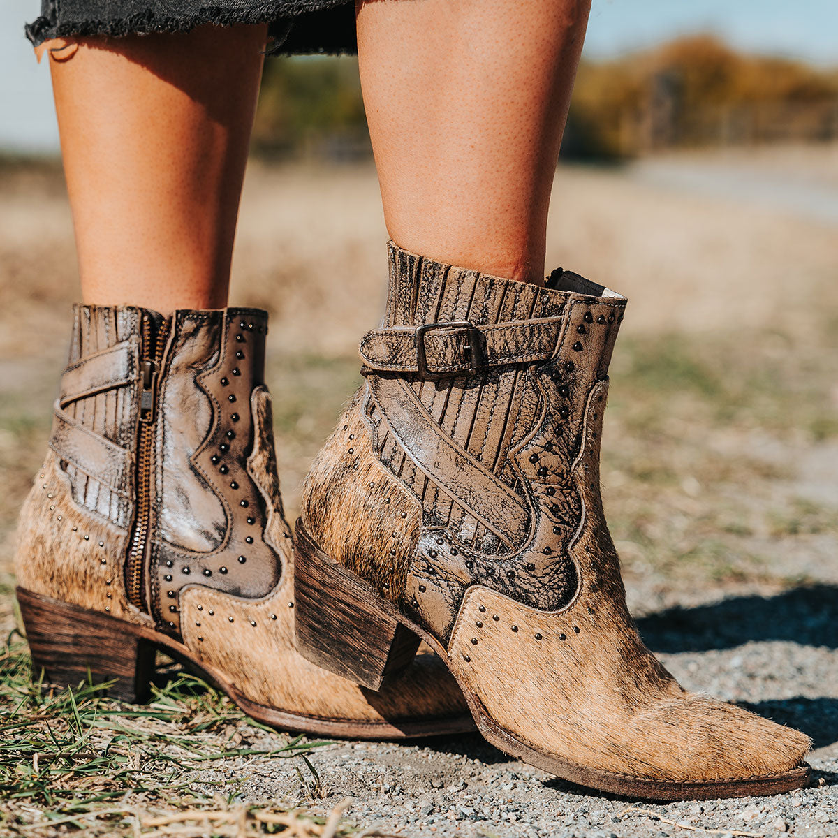 FREEBIRD women's Morgan pewter multi pony leather ankle bootie with silver stud embellishments, gore detailing, and buckle straps