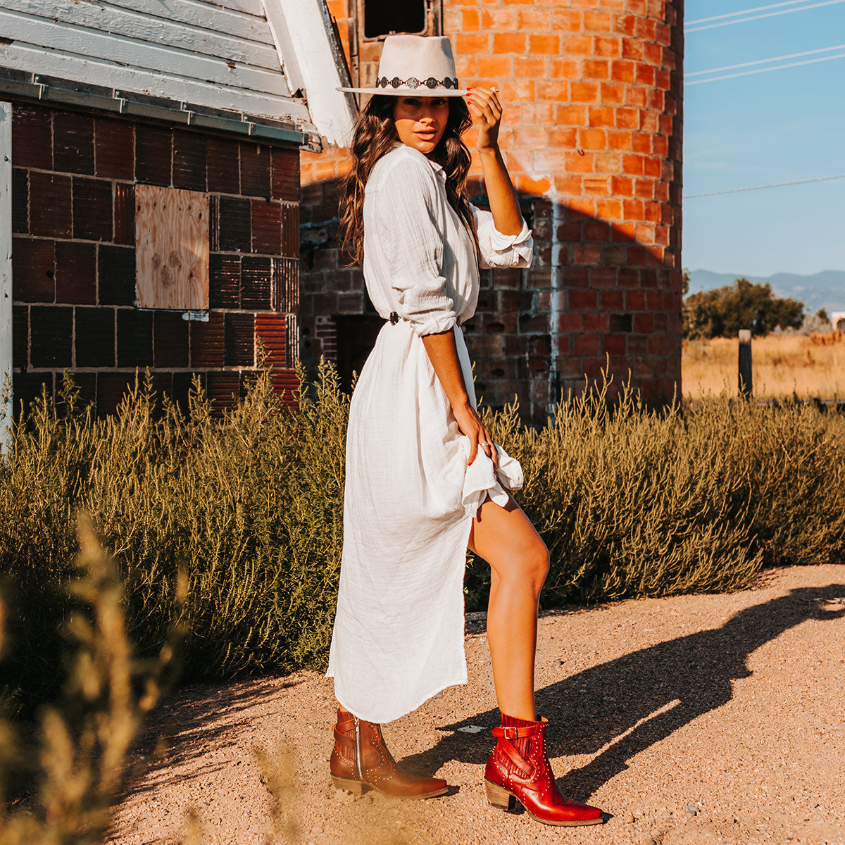 FREEBIRD women's Morgan red leather ankle bootie with silver stud embellishments, gore detailing, and buckle straps lifestyle