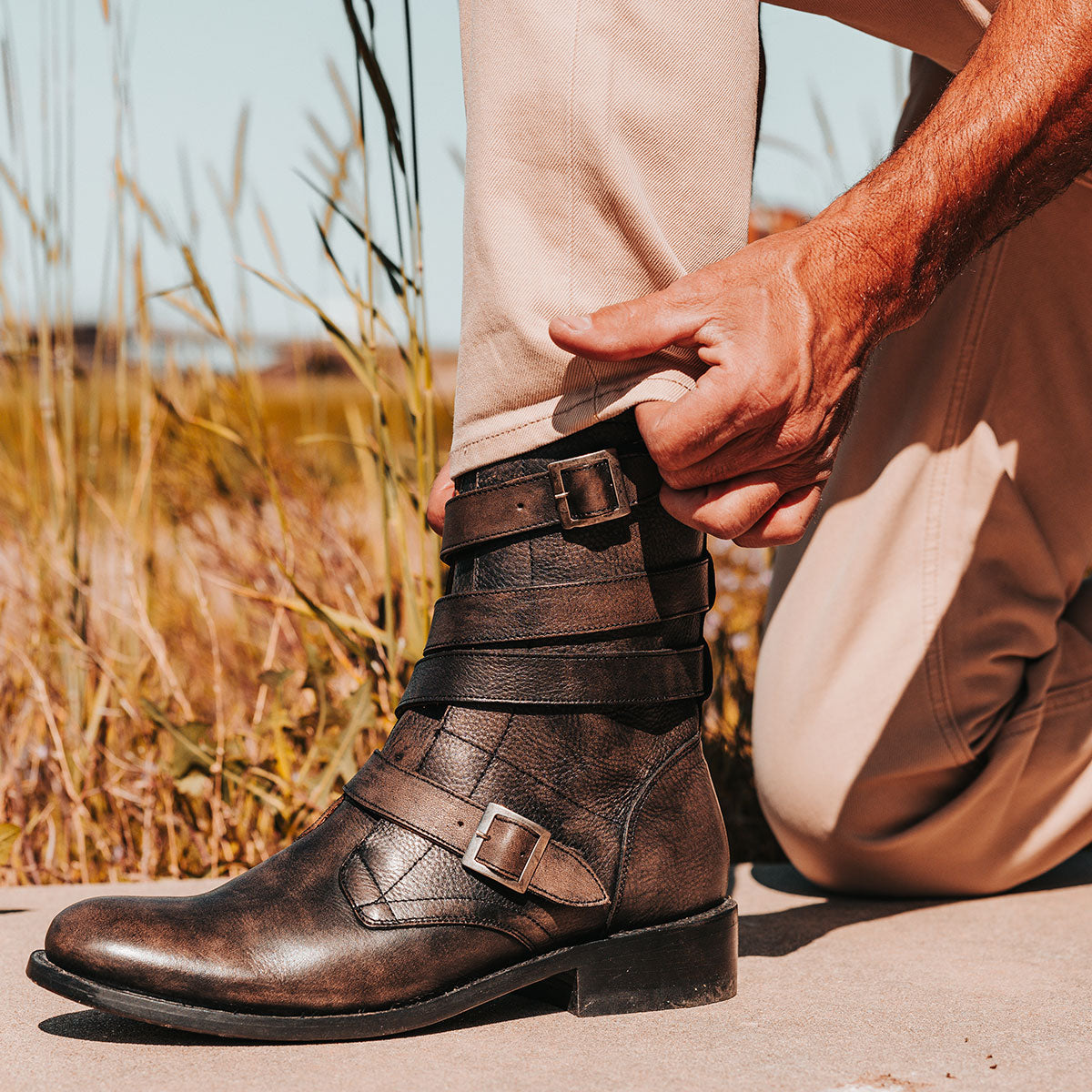 FREEBIRD men's Rumble black distressed leather boot with adjustable leather straps, a working brass zipper and stacked heel