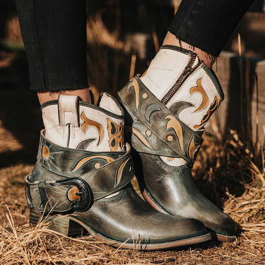 FREEBIRD women's Tash blue multi leather bootie with an inside working zipper, removable belt and laser cut detailing