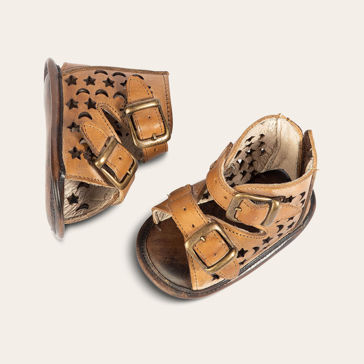 top view showing laser-cut leather, embossed fashion straps, back velcro panel on FREEBIRD infant baby teresa tan leather sandal